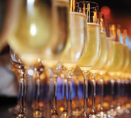 Glasses of champagne lined up in a row